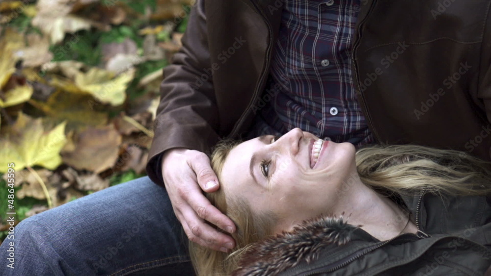 Couple in love sitting in park, super slow motion Couple in love sitting in park, super slow motion