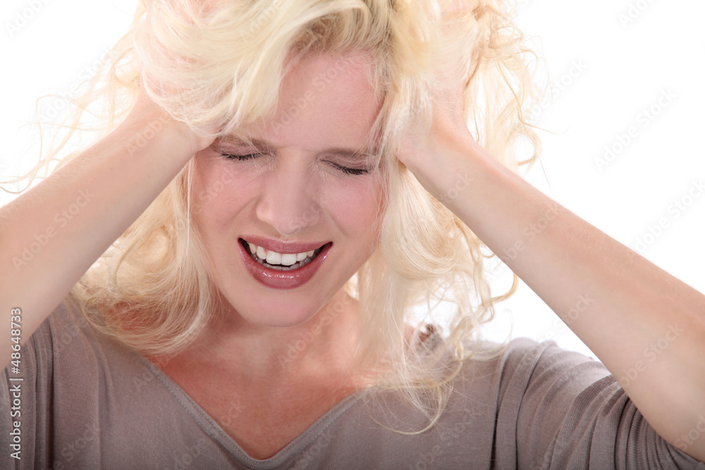 Blond woman suffering from headache Blond woman suffering from headache