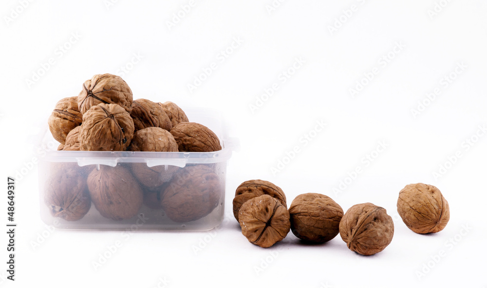 Crisper filled with walnuts on the white background Crisper filled with walnuts on the white background
