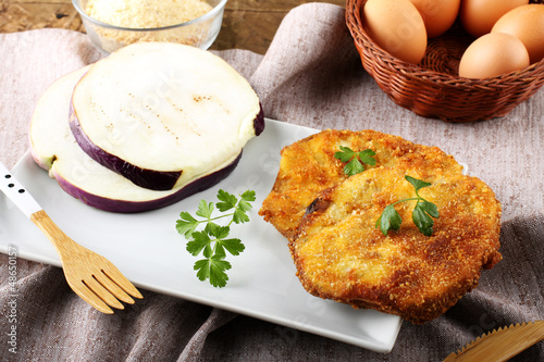 Obraz na płótnie Eggplant cutlet  with beaten egg and breadcrumbs