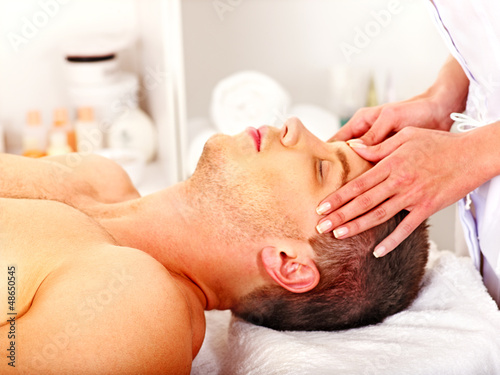 Man getting facial massage .
