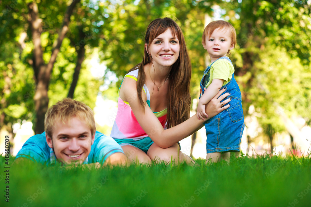 Fototapeta premium baby with parents in a beautiful summer park