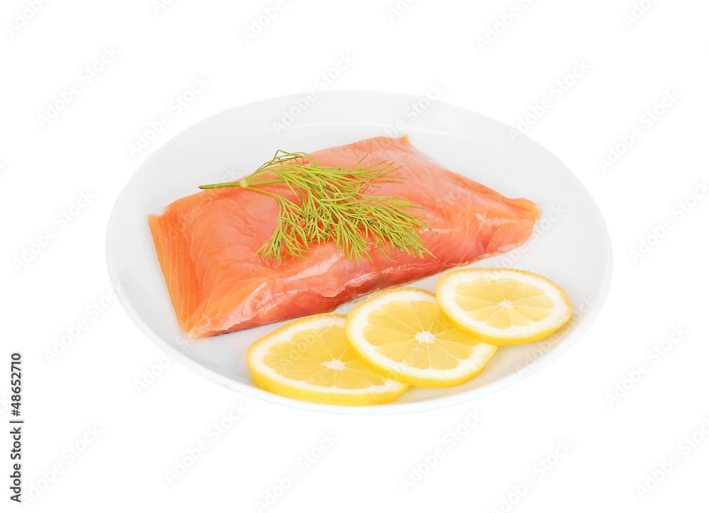 Fresh salmon steak with lemon slice and dill, isolated on white Fresh salmon steak with lemon slice and dill, isolated on white