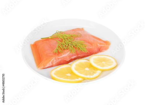 Fresh salmon steak with lemon slice and dill, isolated on white