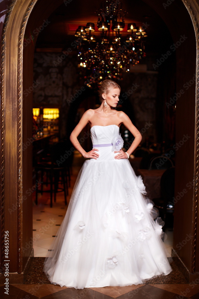 sexy blond bride in white wedding dress in interior sexy blond bride in white wedding dress in interior