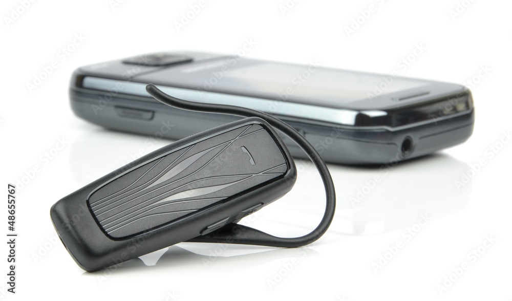 A bluetooth headset and mobile cell phone on white background A bluetooth headset and mobile cell phone on white background