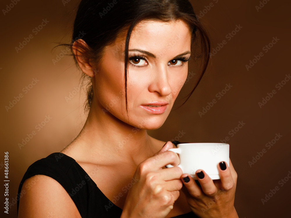 Woman with an aromatic coffee in hands Woman with an aromatic coffee in hands