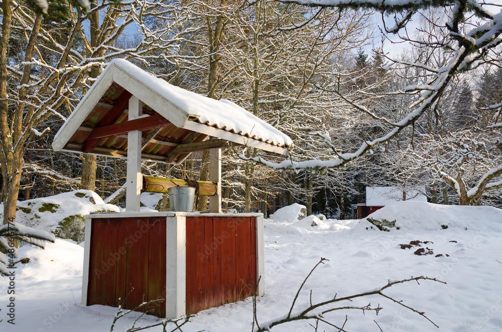 Typical Swedish well in winter season Typical Swedish well in winter season