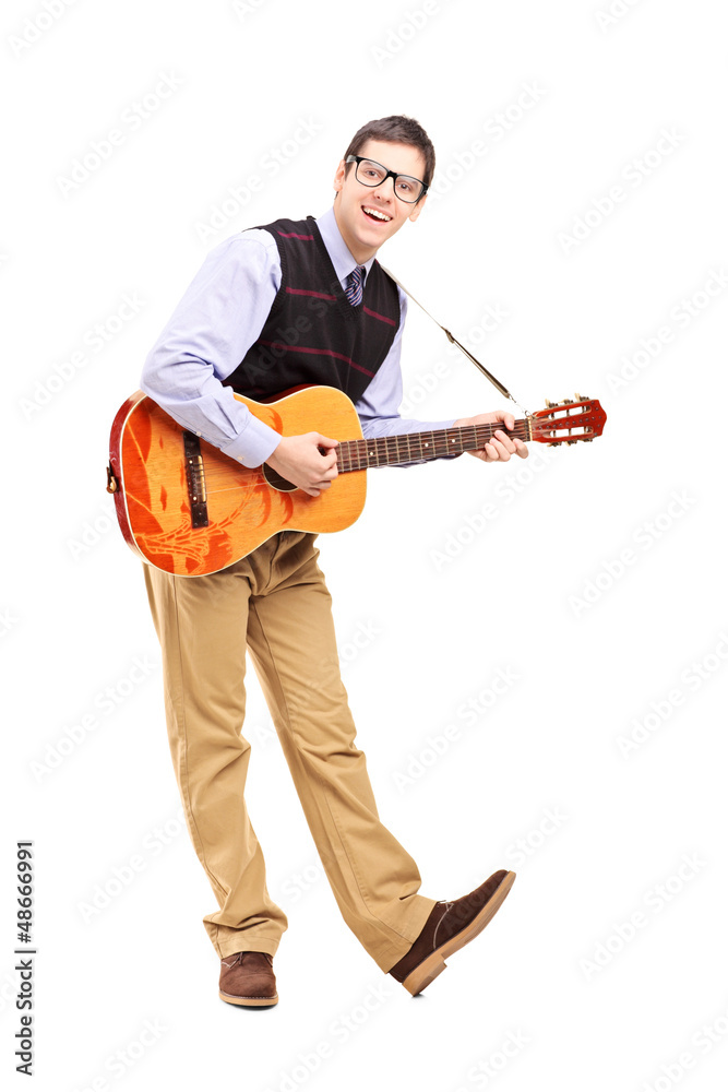 Full length portrait of a young male playing a guitar Full length portrait of a young male playing a guitar