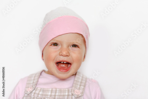 baby girl in hat laughing