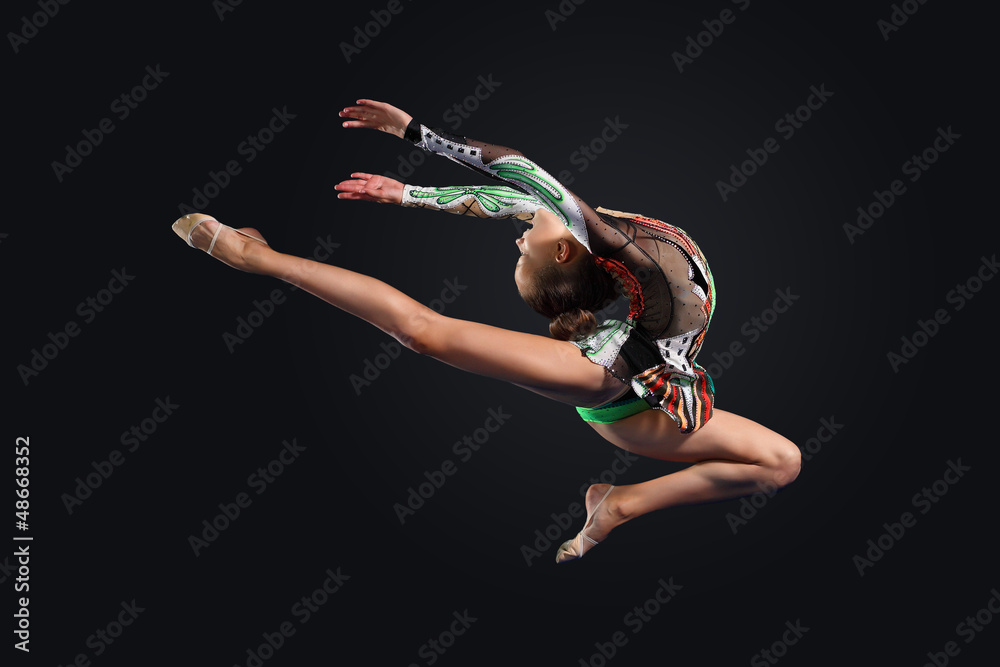 Obraz premium Young woman in gymnast suit posing