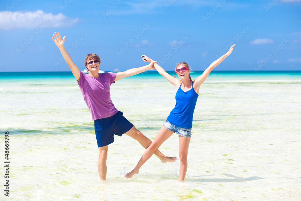 happy young couple having fun on the beach happy young couple having fun on the beach
