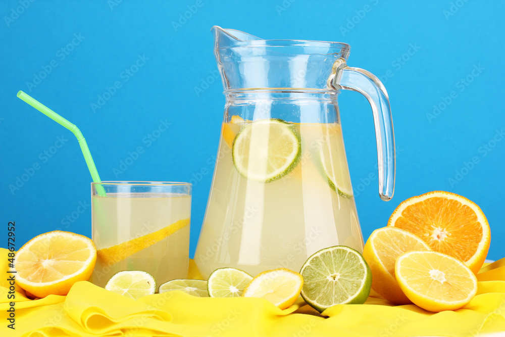 Citrus lemonade in glass and pitcher of citrus around Citrus lemonade in glass and pitcher of citrus around