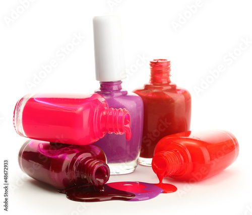 open bottles with bright nail polish isolated on white