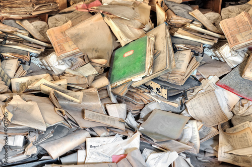Pile of old yellowed documents in an abandoned building photo