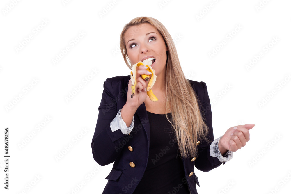Thoughtful woman eating a banana Thoughtful woman eating a banana