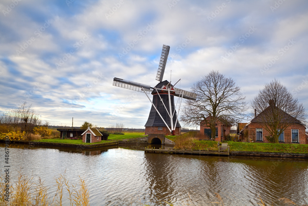 Dutch windmill by canal