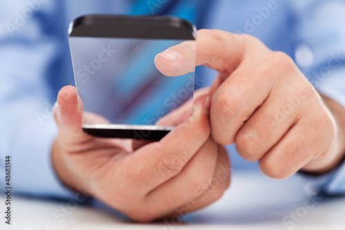 Fototapeta Naklejka Na Ścianę i Meble -  Touchscreen gadget in businessman hands