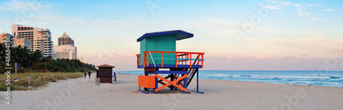 Miami Beach sunset panorama with lifeguard tower and hotels.