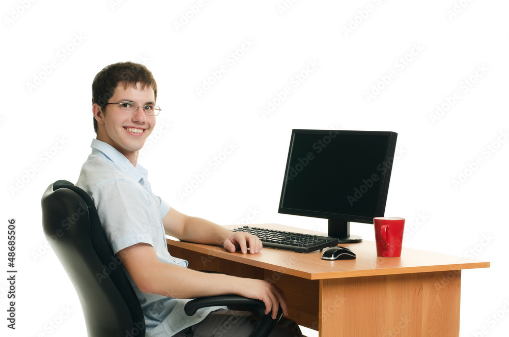 The businessman behind a table with the computer The businessman behind a table with the computer