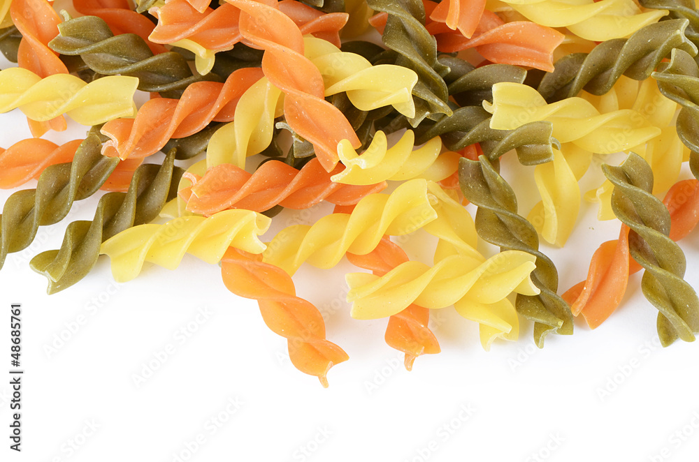 Raw colored pasta fusilli isolated on white background