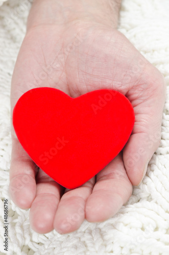 red heart in the palm of a man s