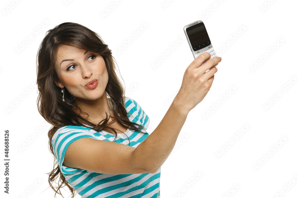 Woman giving kiss while taking pictures through cellphone Woman giving kiss while taking pictures through cellphone