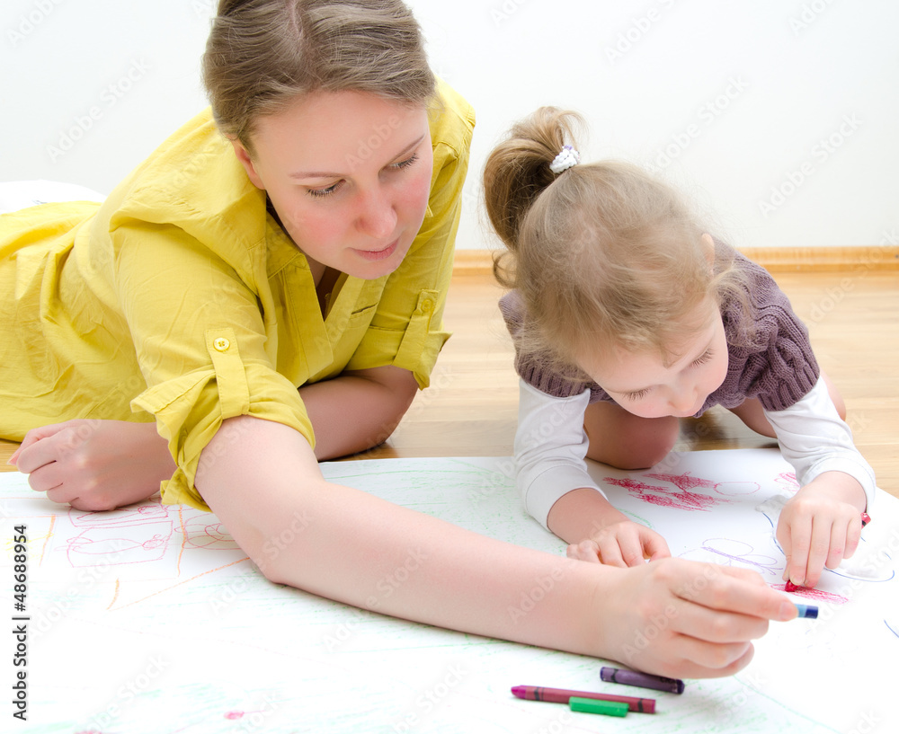 Young woman and little girl drawing together Young woman and little girl drawing together