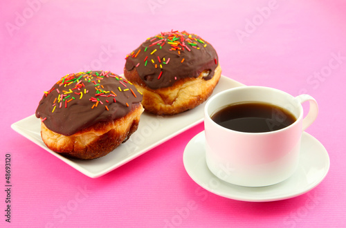 Tasty donuts on color plate on color background