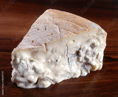 A wedge of gorgonzola cheese photo