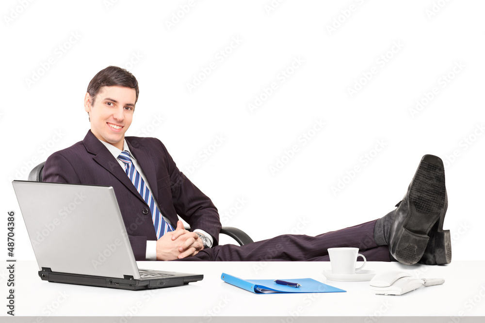 Young businessperson sitting in the office with his legs up Young businessperson sitting in the office with his legs up