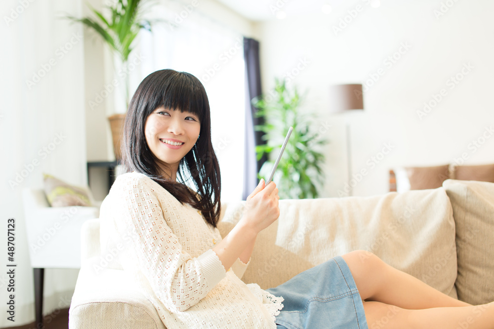 Beautiful asian woman using a tablet computer Beautiful asian woman using a tablet computer