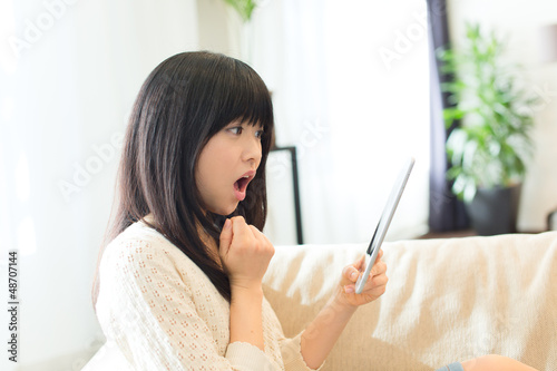 Beautiful asian woman using a tablet computer