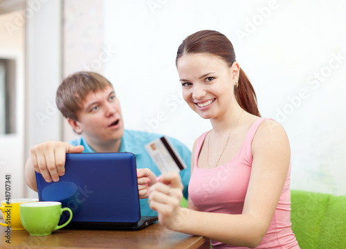 couple buying online with laptop