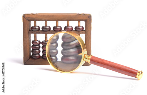 Chinese abacus and Magnifying glass,business concept photo