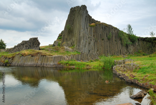 Basalt rock hill and clear pond