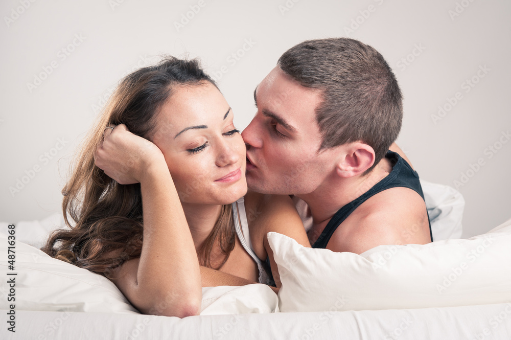 Happy young couple close up portrait in a romantic mood in bedro Happy young couple close up portrait in a romantic mood in bedro