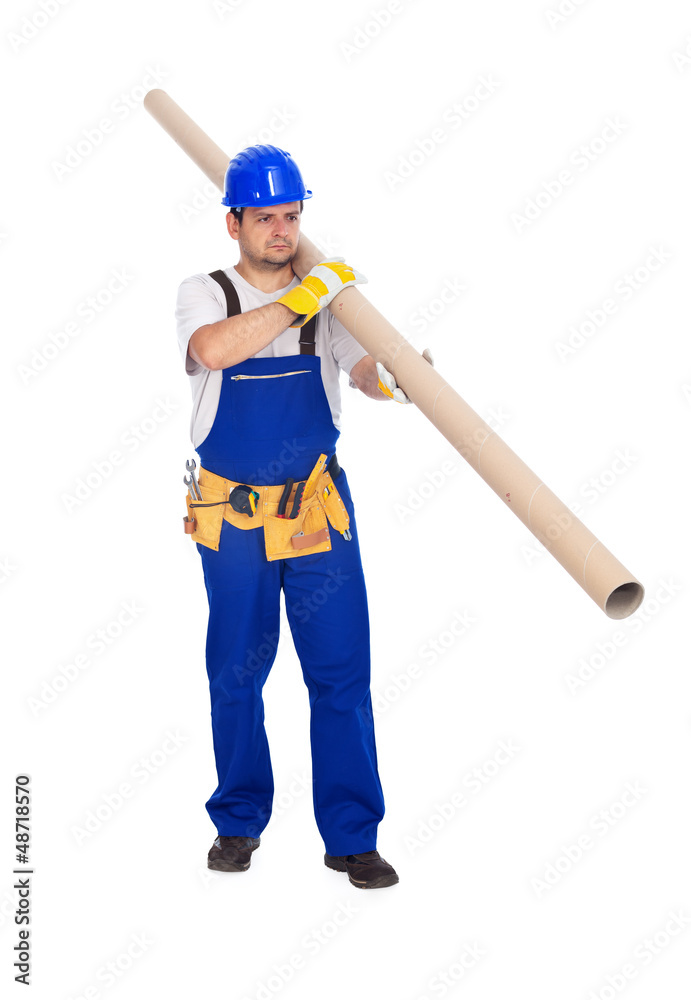 Worker carries long pipe Worker carries long pipe