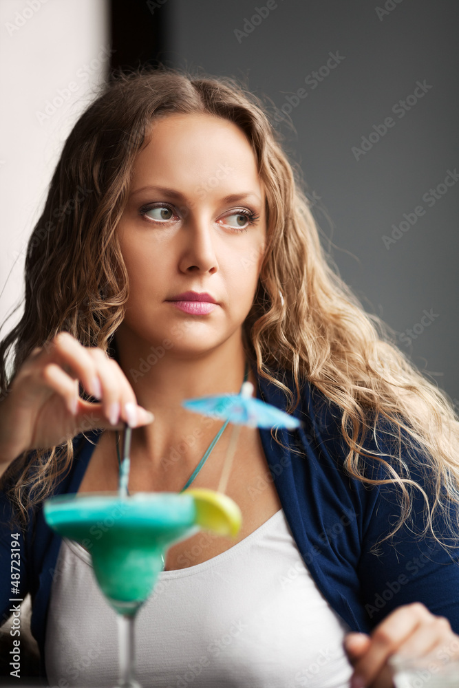 Sad young woman with cocktail at a restaurant Sad young woman with cocktail at a restaurant