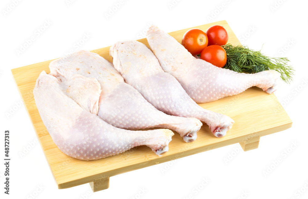 Fresh raw chicken wings on chopping board with roma tomatoes Fresh raw chicken wings on chopping board with roma tomatoes