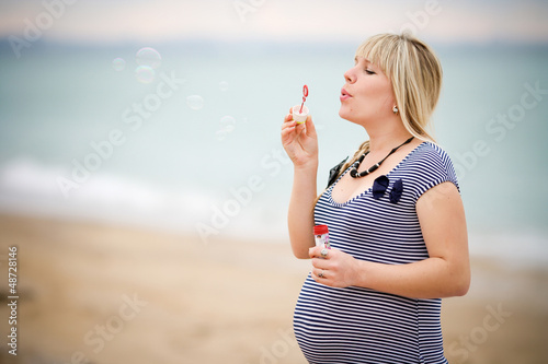 Portrait of beautiful pregnant woman over sea
