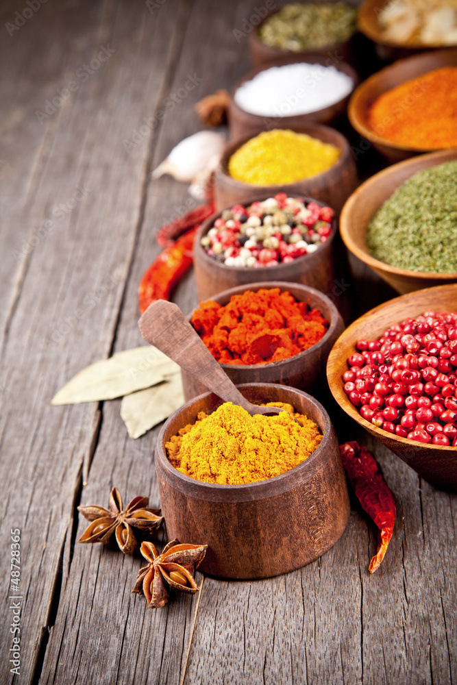 Various kind of spices in wooden bowls Various kind of spices in wooden bowls
