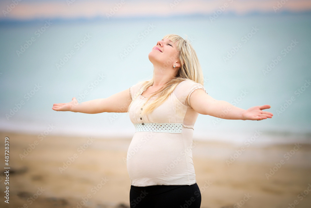 Portrait of beautiful pregnant woman over sea Portrait of beautiful pregnant woman over sea
