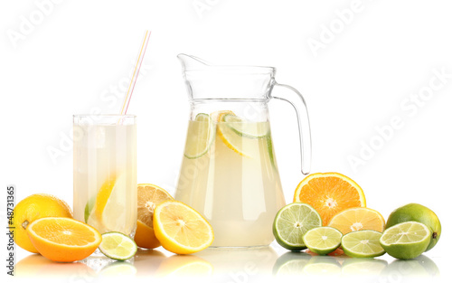 Citrus lemonade in pitcher and glass of citrus around isolated