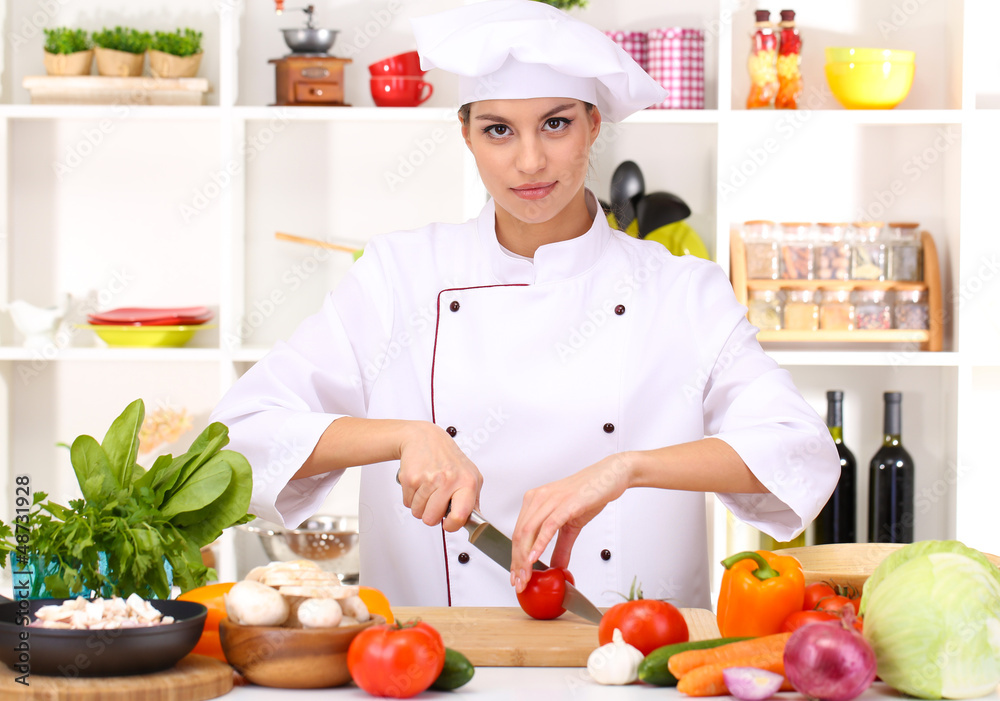 Young woman chef cooking in kitchen Young woman chef cooking in kitchen