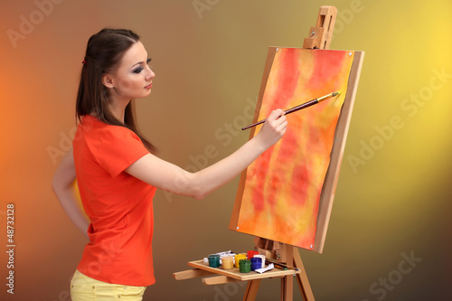 beautiful young woman painter at work, photo