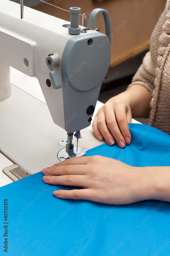 Naklejka premium work at the sewing machine