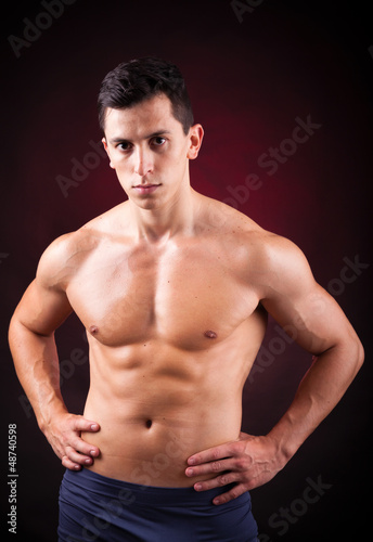 Image of a handsome athletic man on black background