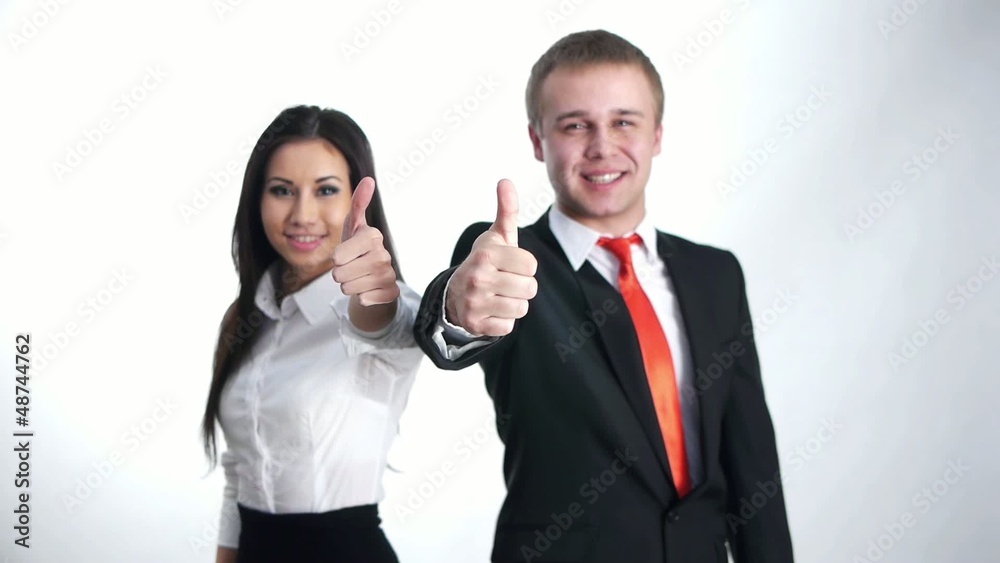 businesspeople showing thumbs up with a smile businesspeople showing thumbs up with a smile