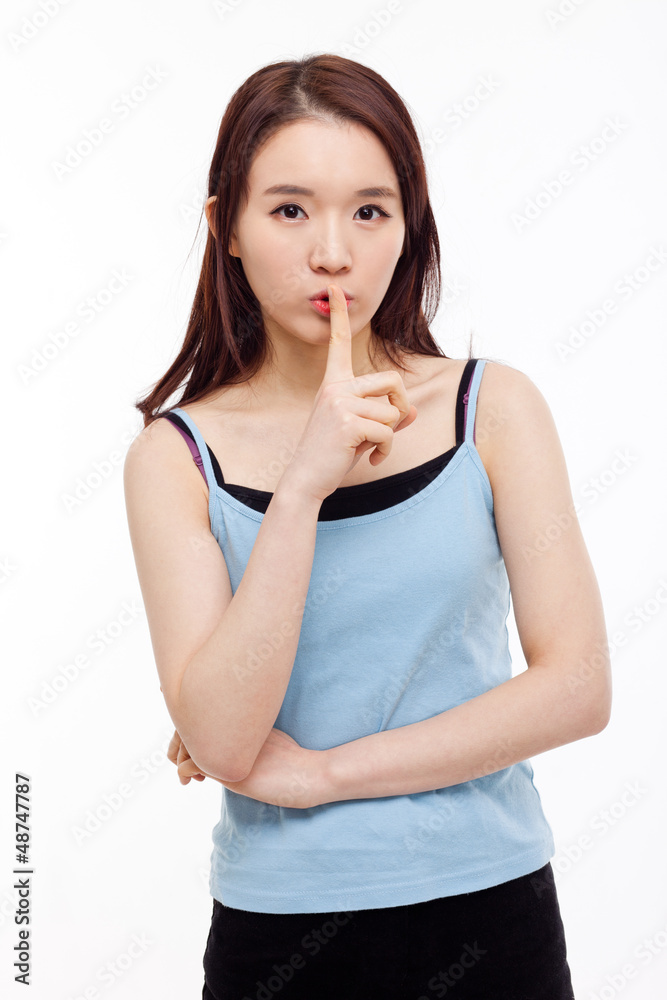 Young Asian woman gesture dont' make sound. Young Asian woman gesture dont' make sound.
